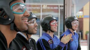 Four people with skydiving outfits on